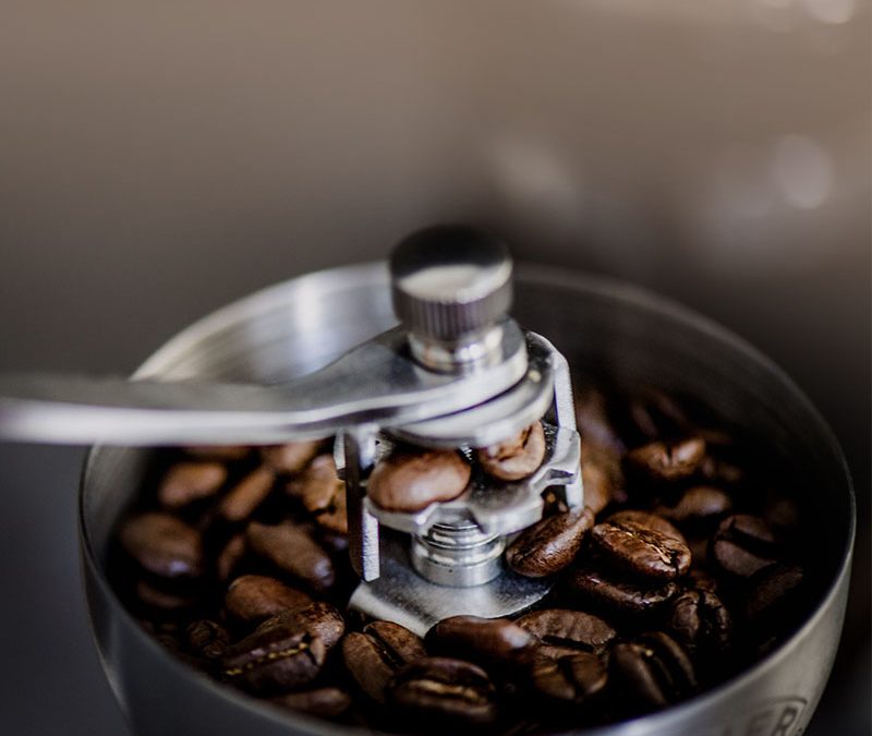 Coffee grinder with coffee beans in the top