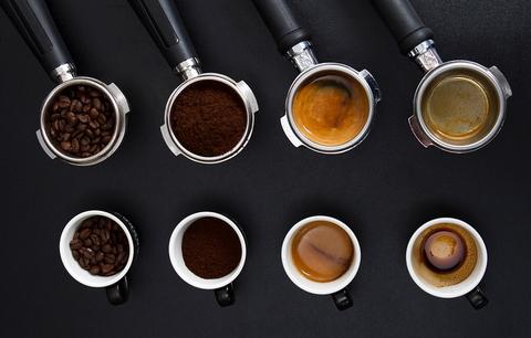 Coffee tasting espresso handles with brewed coffees on a table